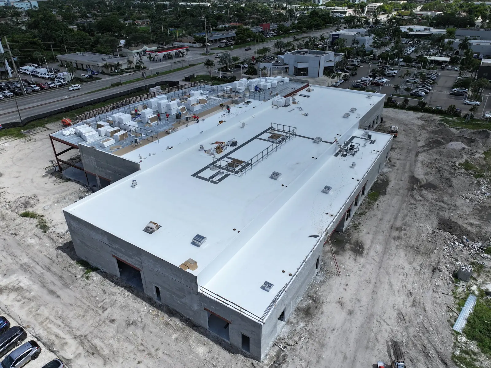 Commercial building with a white TPO roof installed by Millennium Makeover