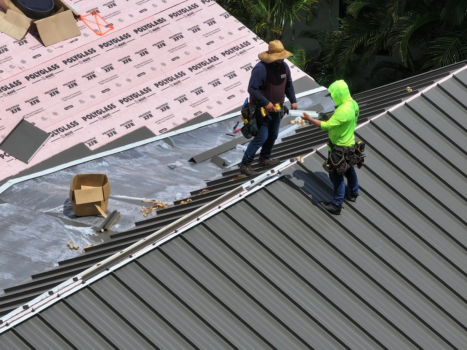Millennium Makeover crew installing standing seam metal roof panels