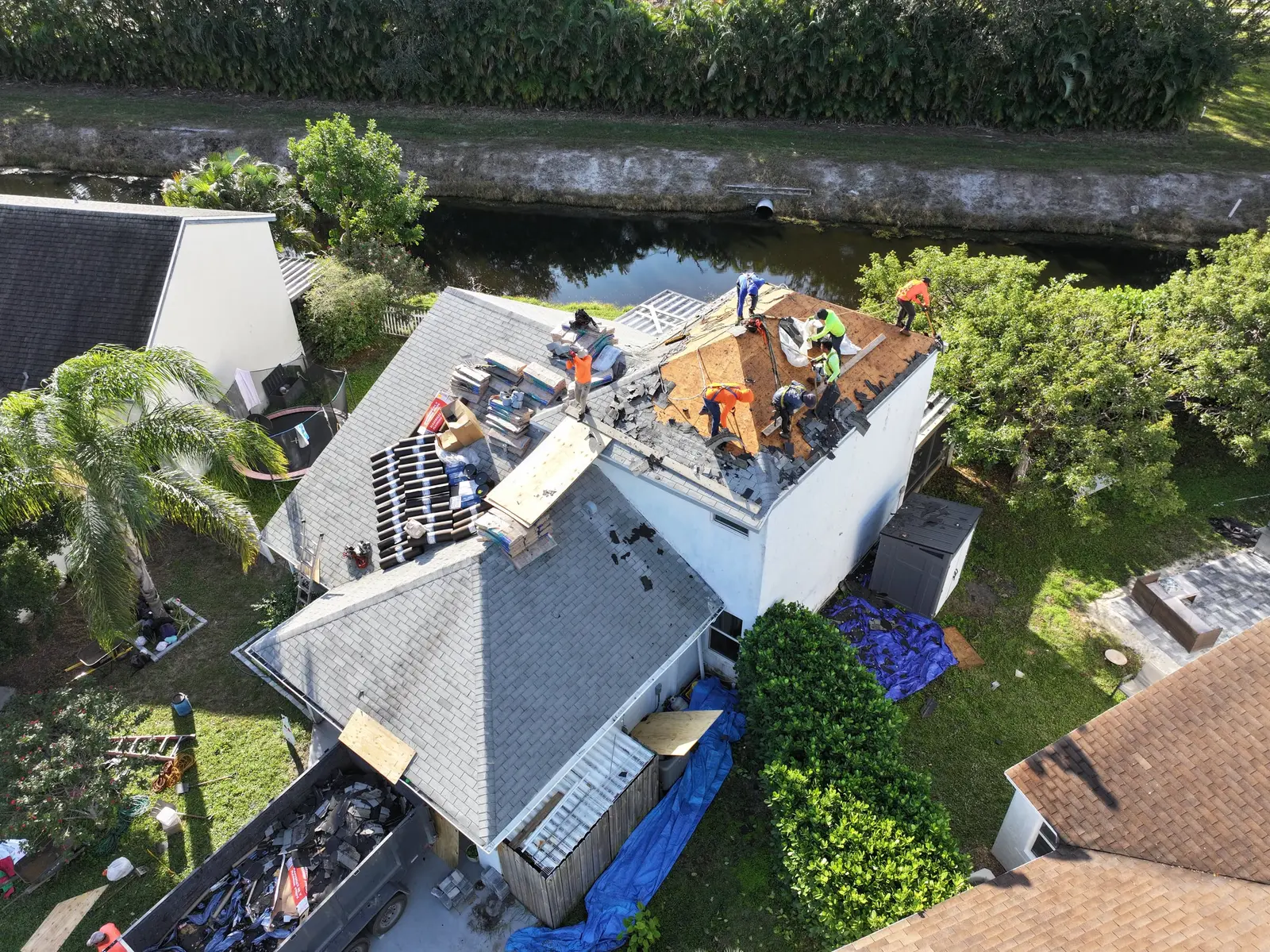Millennium Makeover crew tearing off an old shingle roof before replacement