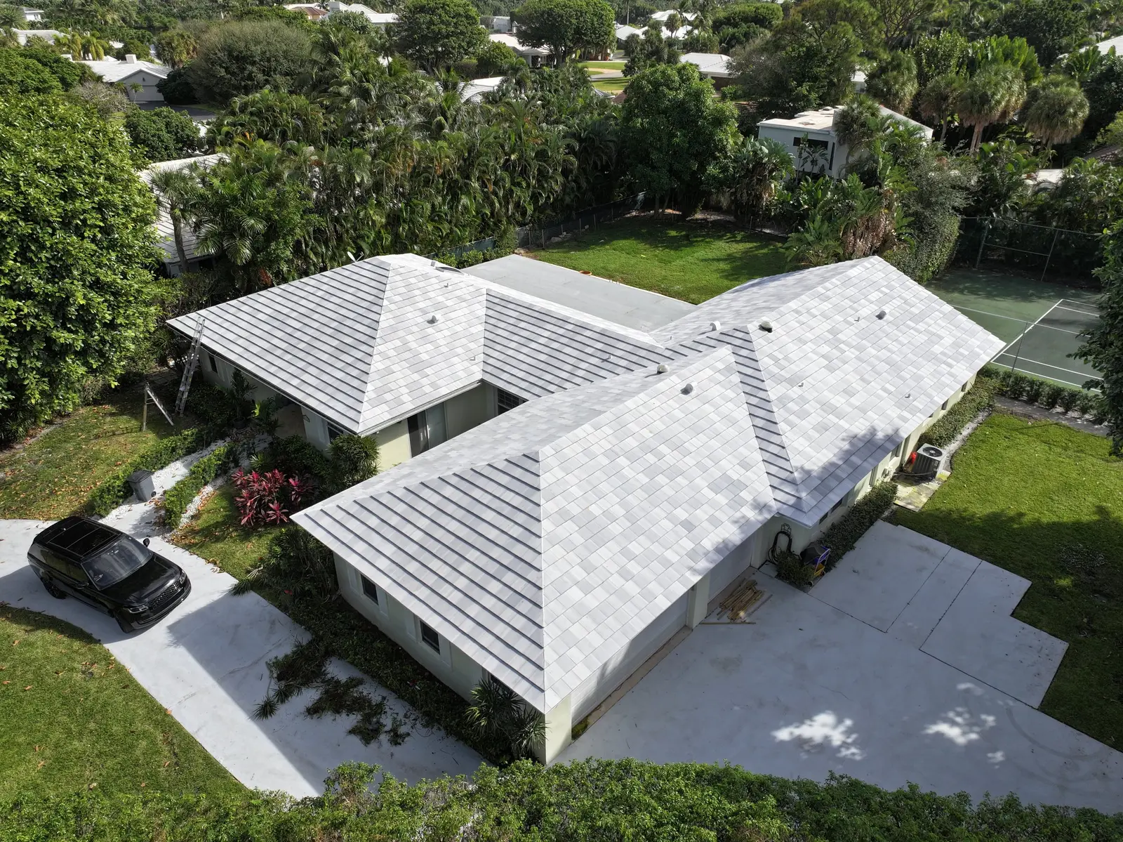 Aerial view of a Florida home with a light tile roof by Millennium Makeover